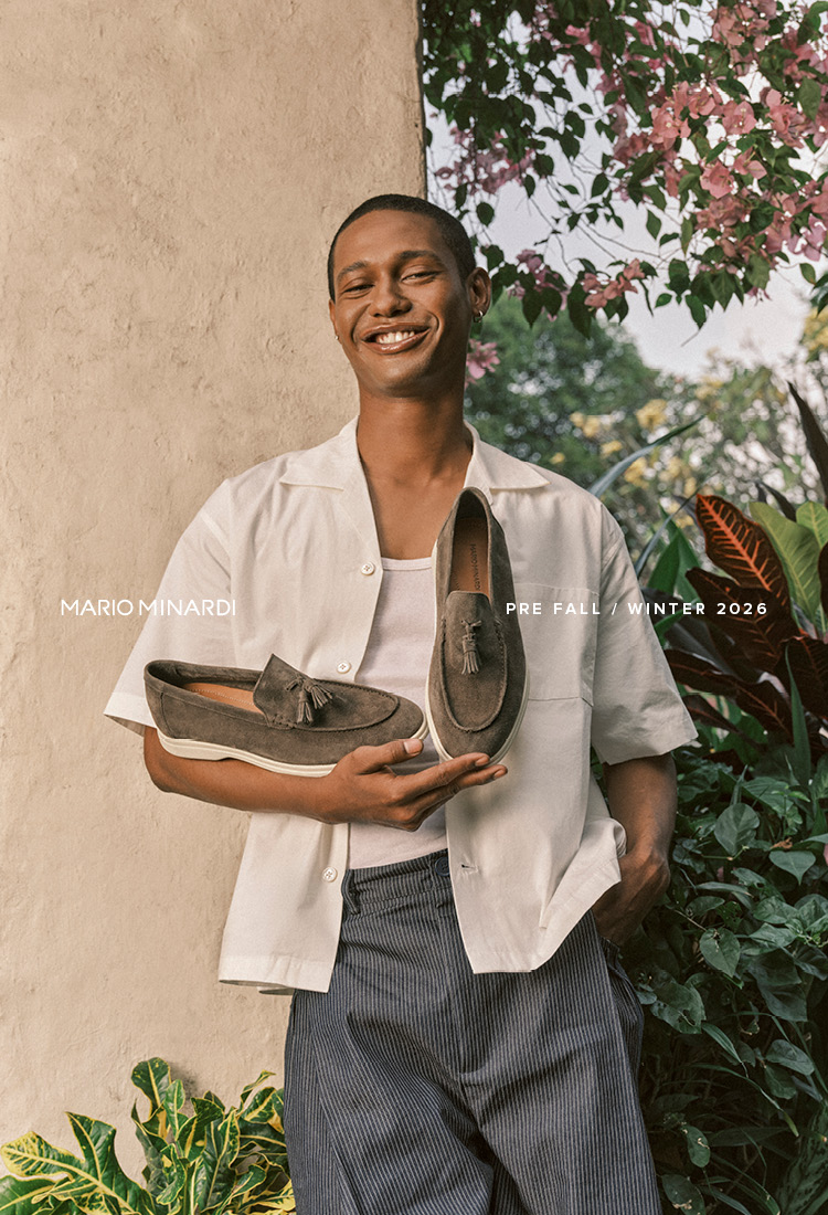 A model holding a pair of shoes
