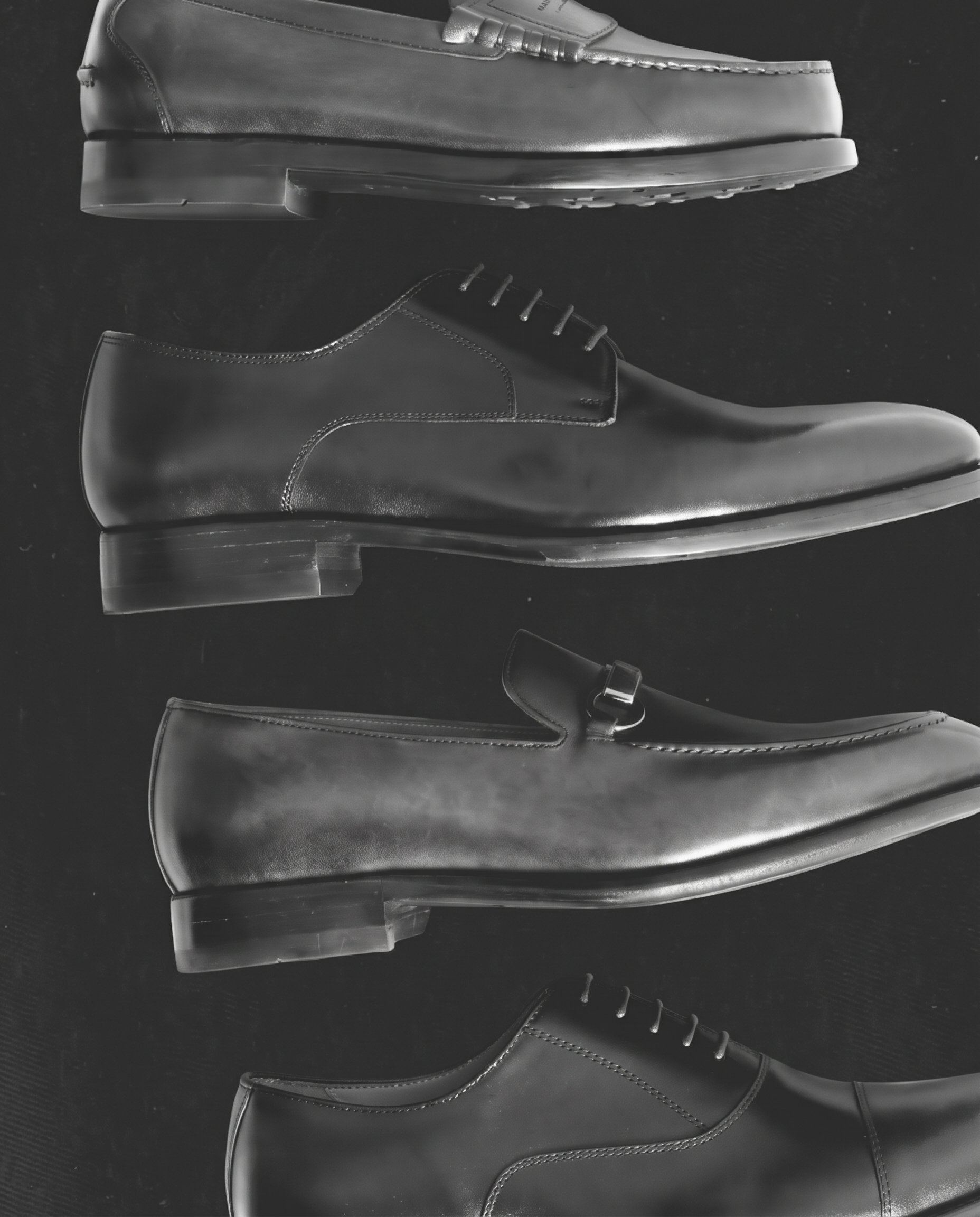 A pair of loafers held against foliage