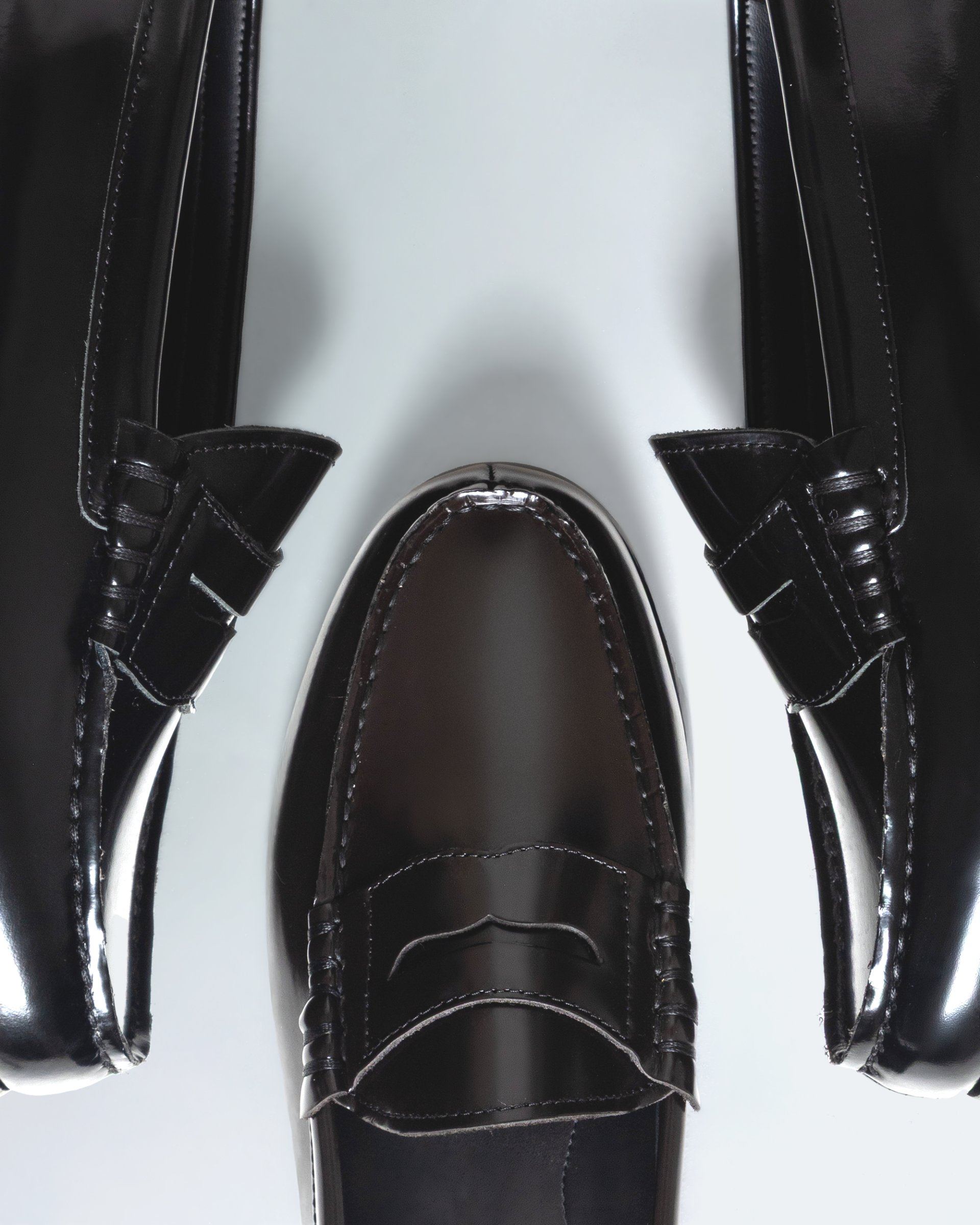 A model holding a pair of loafers